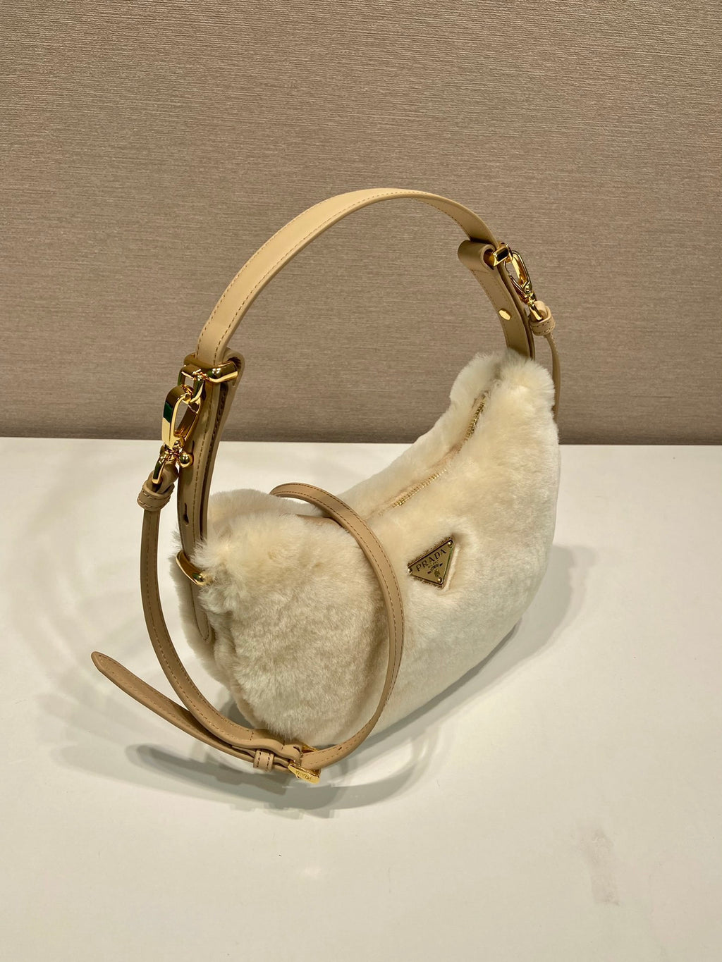 Prada Arqué shearling and leather shoulder bag