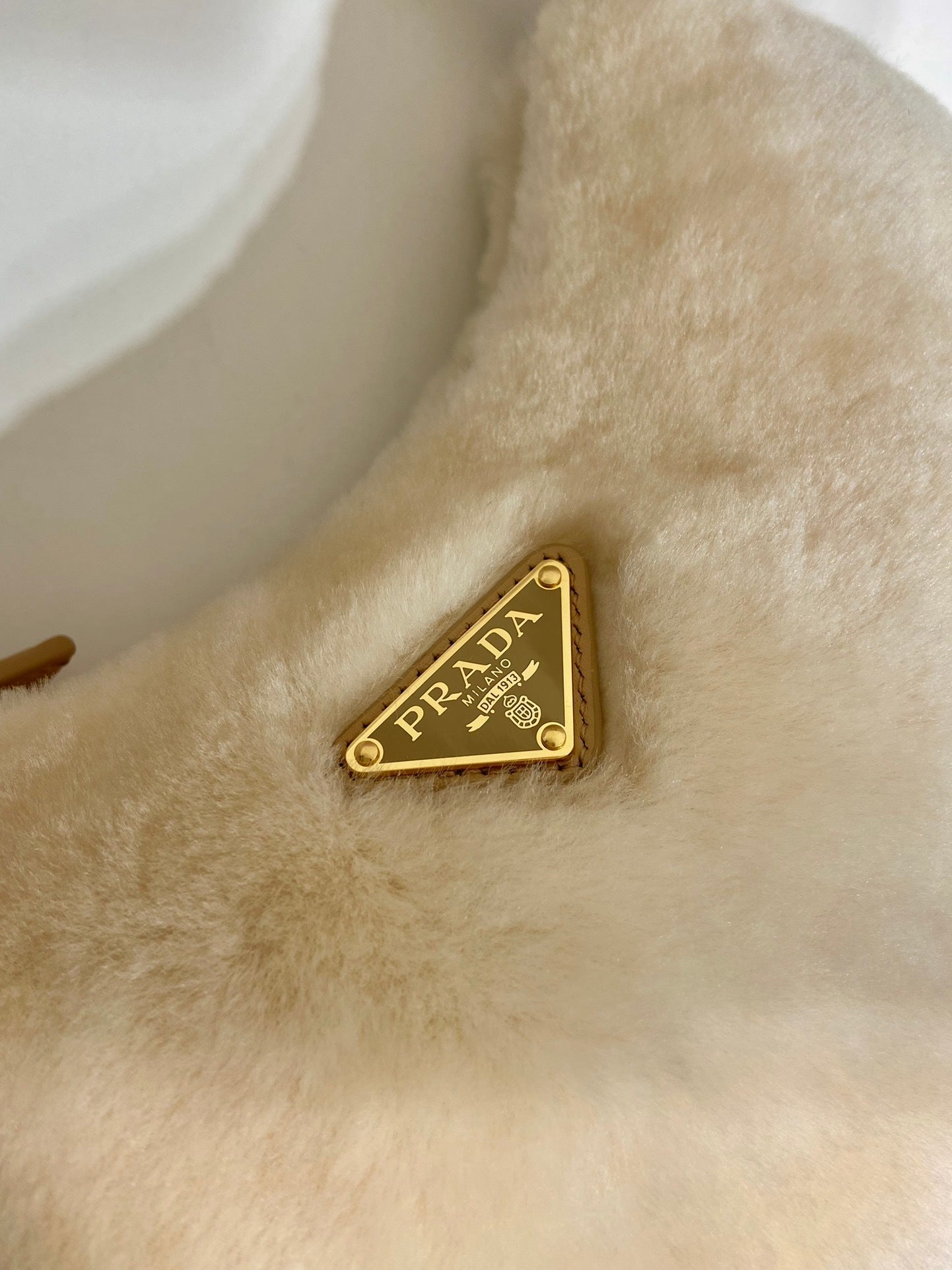 Prada Arqué shearling and leather shoulder bag