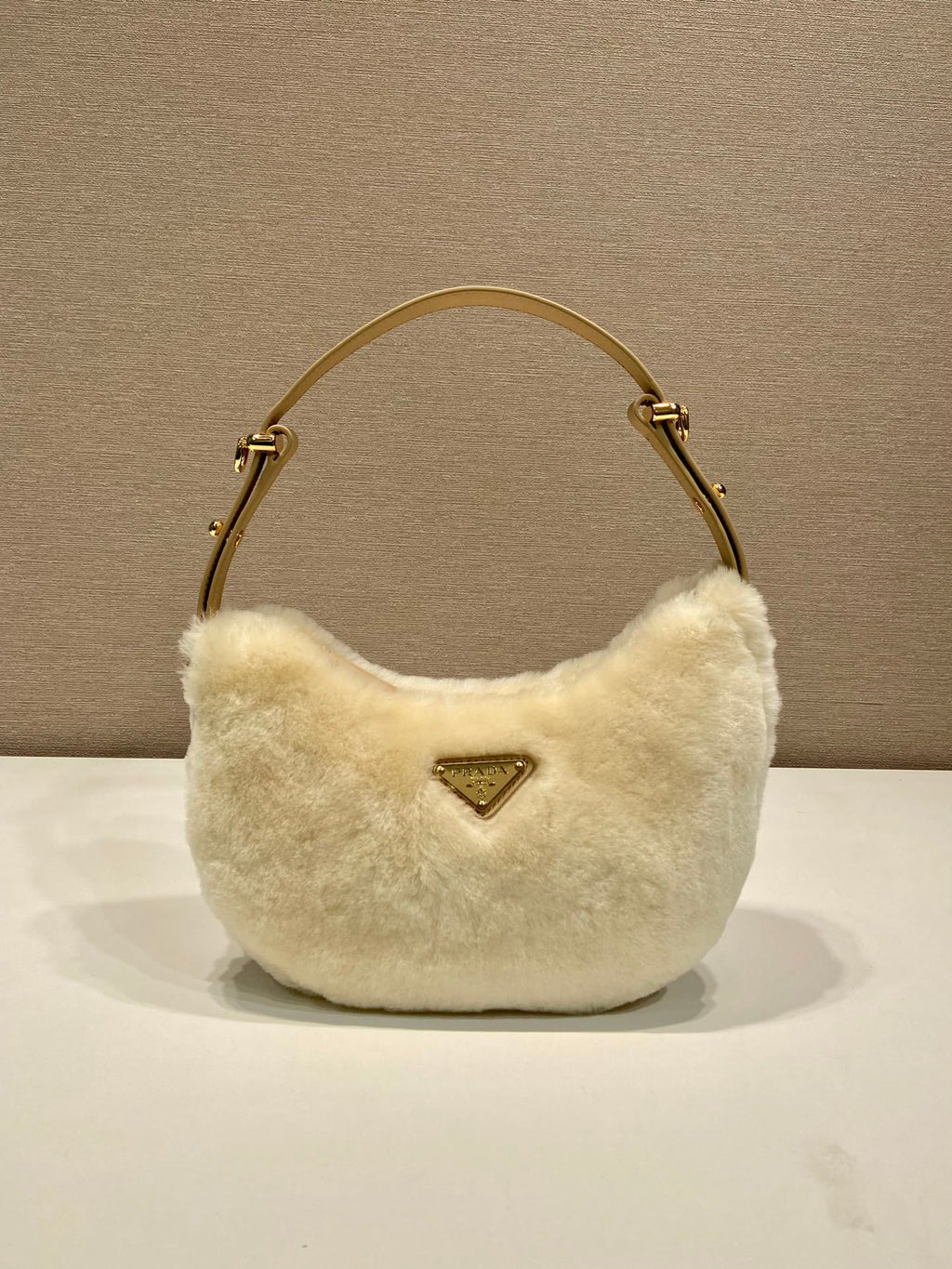 Prada Arqué shearling and leather shoulder bag