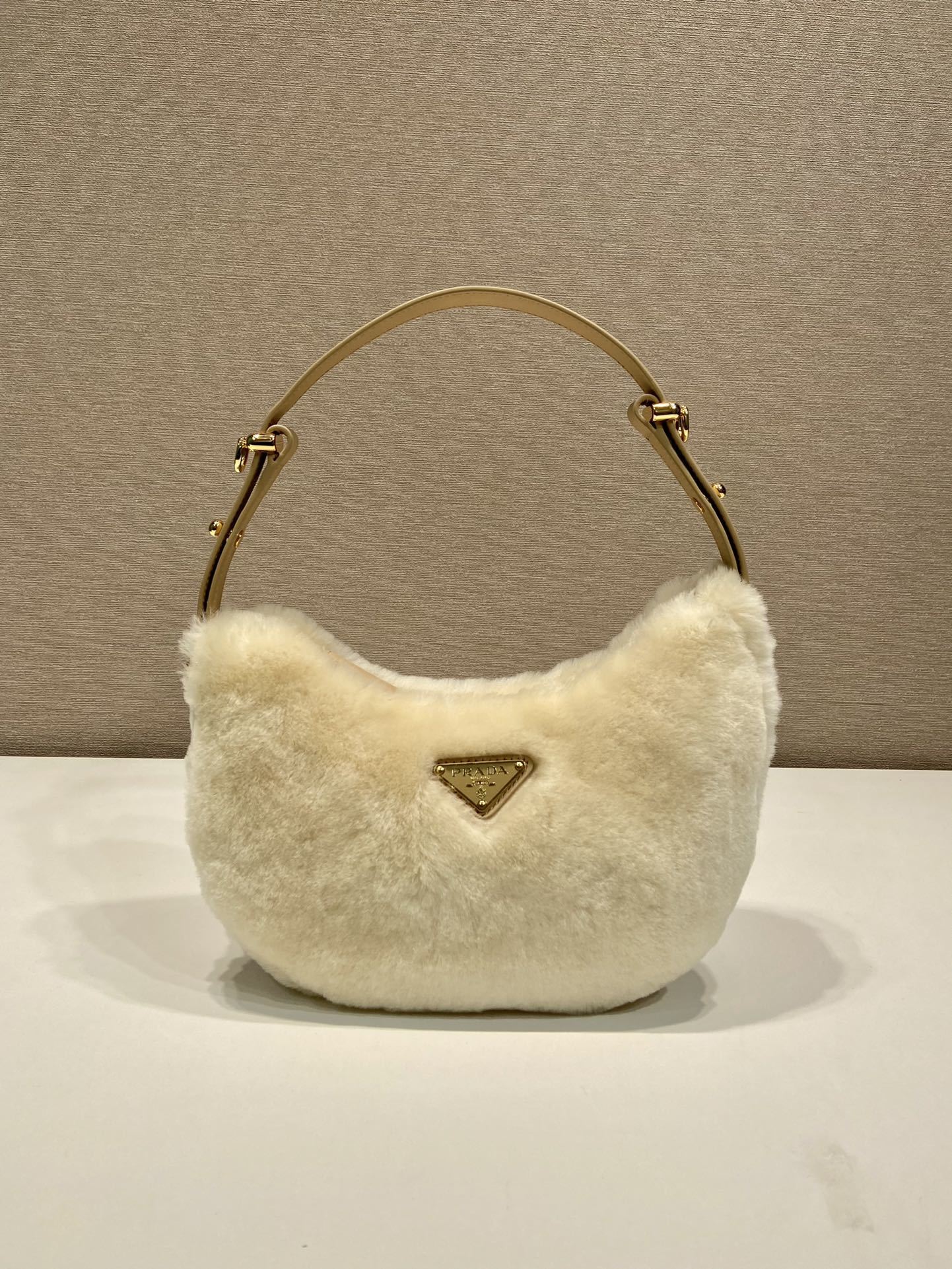 Prada Arqué shearling and leather shoulder bag
